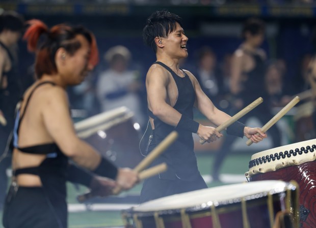 Drummers perform a pregame ceremony before a game between the...