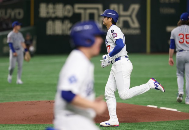 Dodgers designated hitter Shohei Ohtani (17) heads to the dugout...