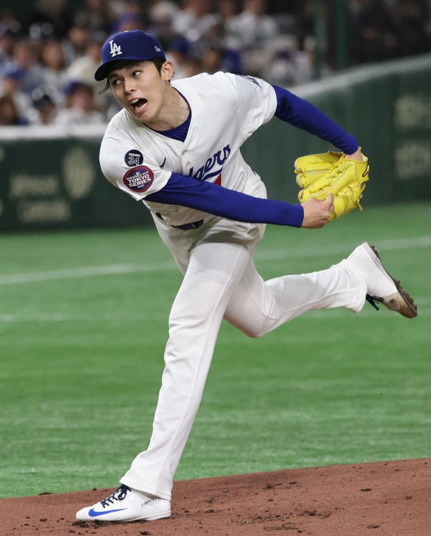 Dodgers starting pitcher Roki Sasaki (11) throws against the Cubs...