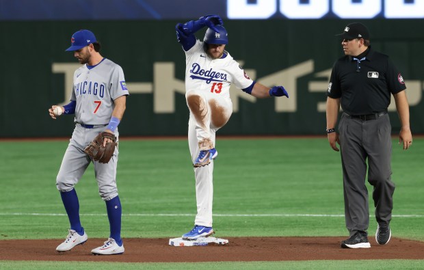 Dodgers third baseman Max Muncy (13) gestures toward teammates after...