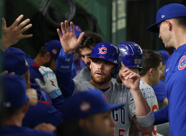 Cubs catcher Carson Kelly (15) is congratulated after scoring off...