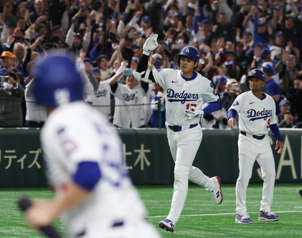 Dodgers designated hitter Shohei Ohtani rounds the bases after hitting...
