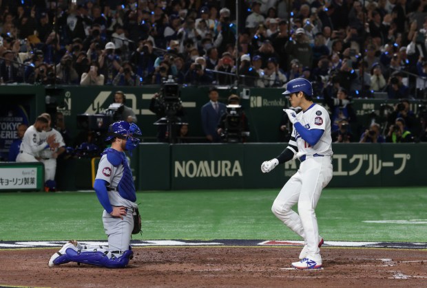 Cubs catcher Carson Kelly, waits for Dodgers designated hitter Shohei...