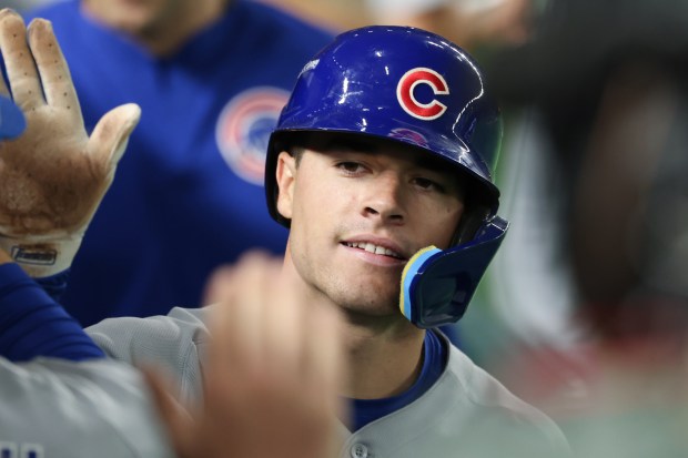 Cubs third baseman Matt Shaw is congratulated after scoring off...