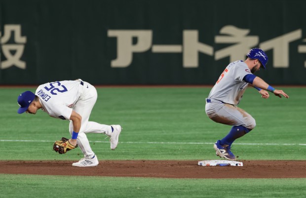 Cubs second baseman Jon Berti (5) is forced out at...