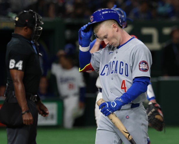 Cubs center fielder Pete Crow-Armstrong (4) takes off his batting...