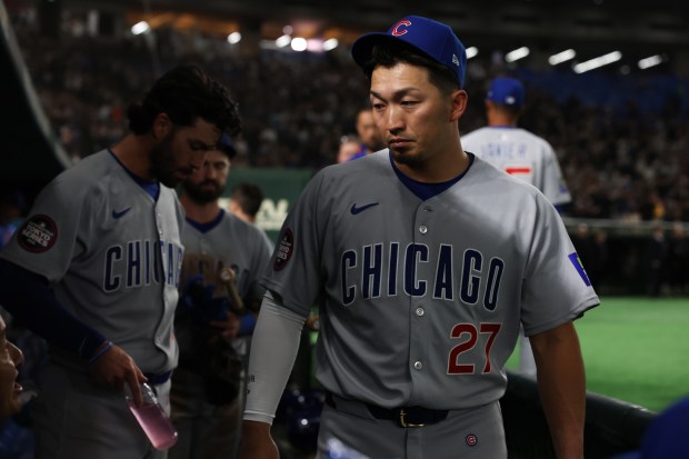 Cubs designated hitter Seiya Suzuki (27) walks through the dugout...
