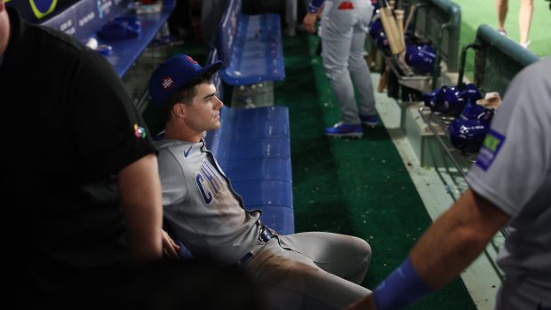 Cubs third baseman Matt Shaw sits on a bench in...