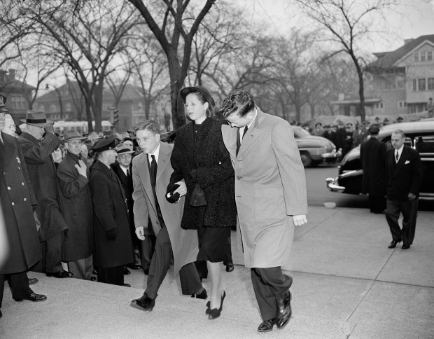 Violet Bidwill, widow of sportsman Charles W. Bidwill Sr., enters the church with her sons William, left, and Charles Jr., for funeral services for Bidwill Sr., April 22, 1947. (Ed Maloney/AP)