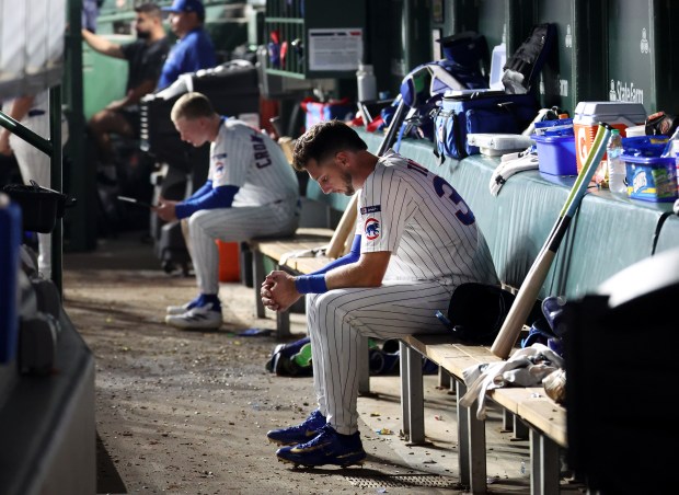 Cubs outfielders Kyle Tucker, right, and Pete Crow-Armstrong sit in the dugout in the ninth inning of a loss to the Reds on Aug. 5, 2025, at Wrigley Field. (Chris Sweda/Chicago Tribune)