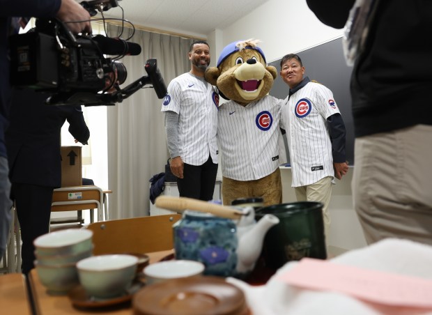 Former Cubs players Derrek Lee, left, and Kosuke Fukudome take...