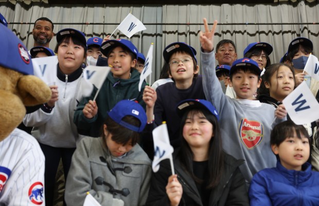 Former Cubs players Derrek Lee, top left, and Kosuke Fukudome,...