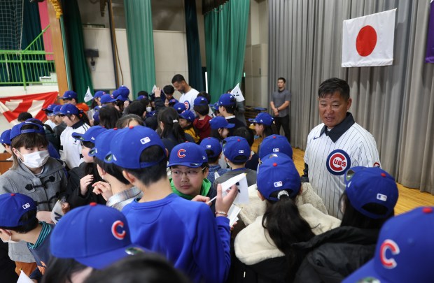 Former Cubs player Kosuke Fukudome interacts with students during an...