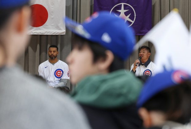Former Cubs players Derrek Lee, left, and Kosuke Fukudome answer...