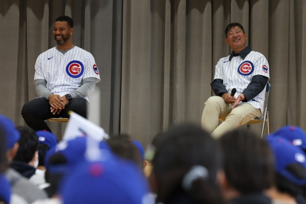 Former Cubs players Derrek Lee, left, and Kosuke Fukudome answer...