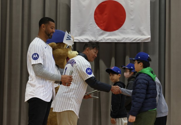 Former Cubs players Derrek Lee, left, and Kosuke Fukudome are...