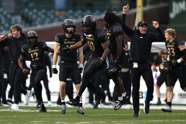 Ricky Ahumaraeze and Northwestern celebrate a 38-35 win over Minnesota on Nov. 22, 2025, at Wrigley Field. (Geoff Stellfox/Getty Images)