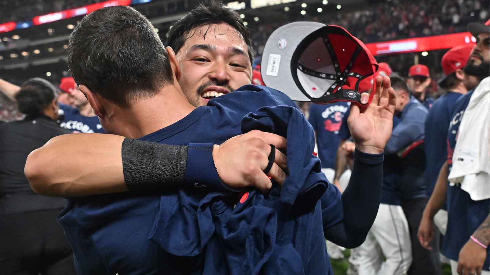Cleveland Guardians left fielder Steven Kwan (38) hugs president of baseball operations Chris Antonetti after the Guardians beat the Texas Rangers to secure a playoff berth at Progressive Field.