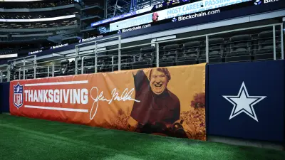 Nov 27, 2025; Arlington, Texas, USA; A banner featuring former NFL head coach John Madden is seen on the field prior to the game between the Kansas City Chiefs and Dallas Cowboys at AT&T Stadium.