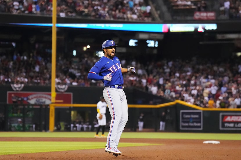 Texas Rangers’ Marcus Semien celebrates hitting a two-run home run during the ninth inning...