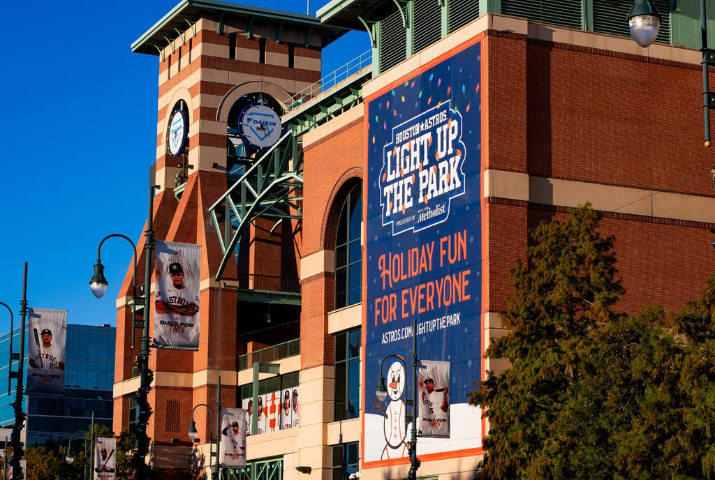 Image shows the facade of Daikin Park featuring a large banner advertising Astros Light Up The Park.