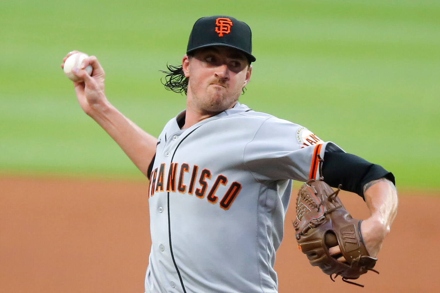ATLANTA, GA - AUGUST 27: Kevin Gausman #34 delivers a pitch in the first inning of an MLB game against the Atlanta Braves at Truist Park on August 27, 2021 in Atlanta, Georgia. (Photo by Todd Kirkland/Getty Images)