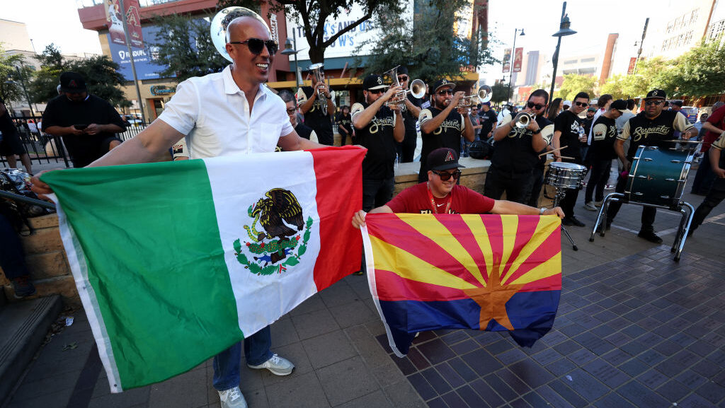 Fans pose with the Mexico and Arizona flags before Game Three of the World Series Arizona Diamondba...