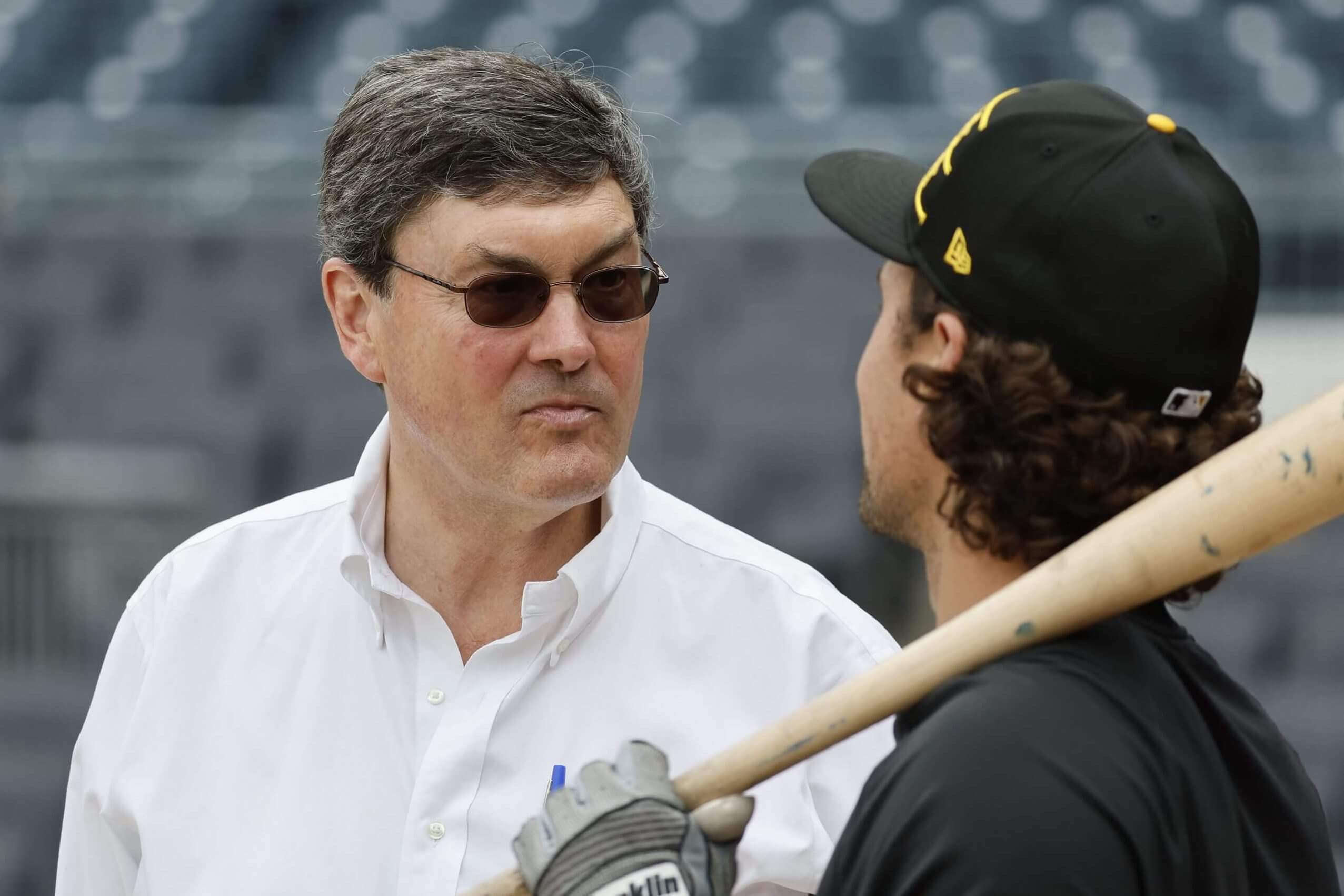 Pirates owner Bob Nutting speaks with then-Pirates infielder Adam Frazier before the team's home opener on April 4, 2025, the same day a plane flew a banner above PNC Park imploring Nutting to "Sell the team".