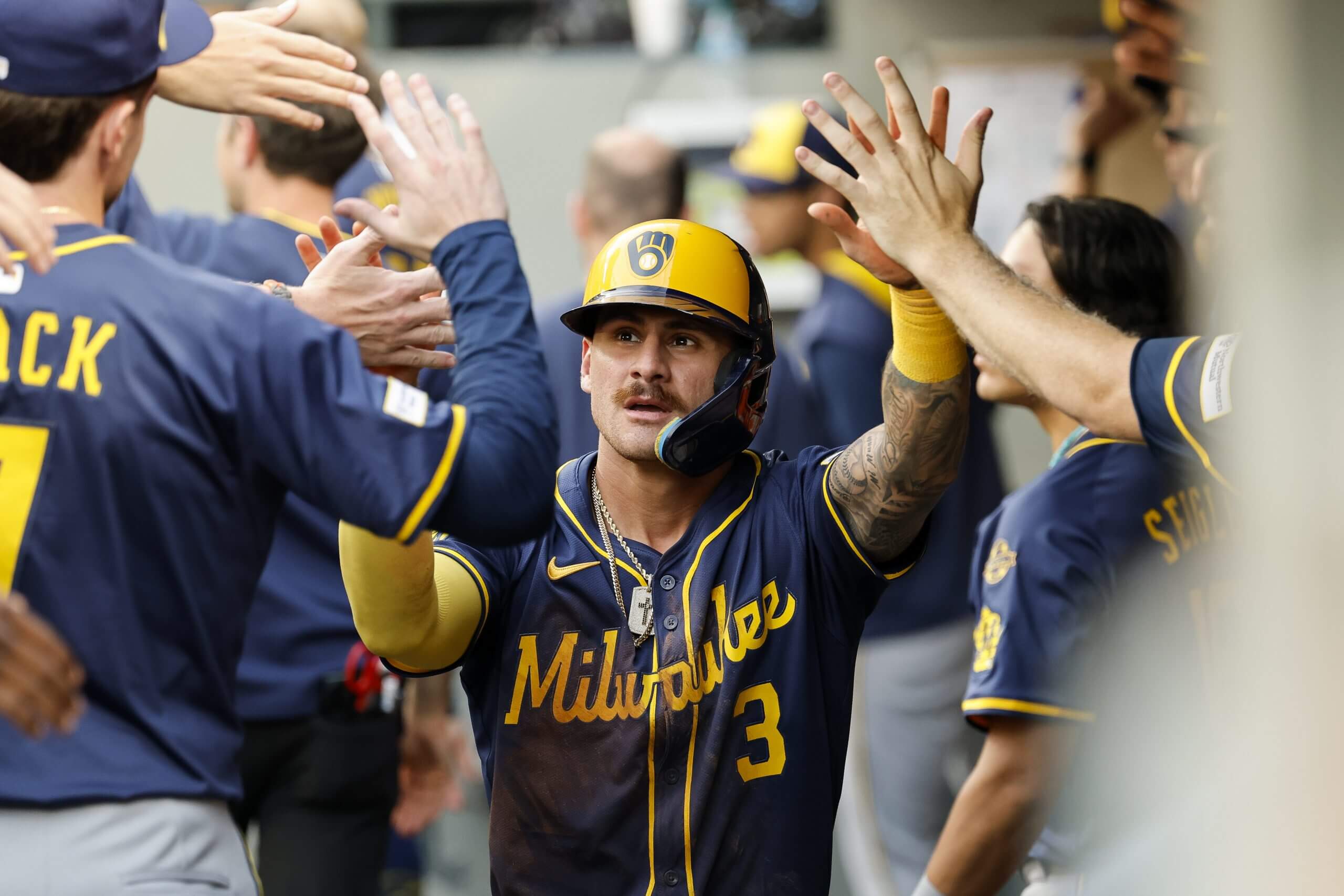 Joey Ortiz of the Milwaukee Brewers celebrates with teammates in the dugout after scoring off of William Contreras' (not pictured) sacrifice fly during the sixth inning against the Seattle Mariners at T-Mobile Park on July 21, 2025 in Seattle, Washington.