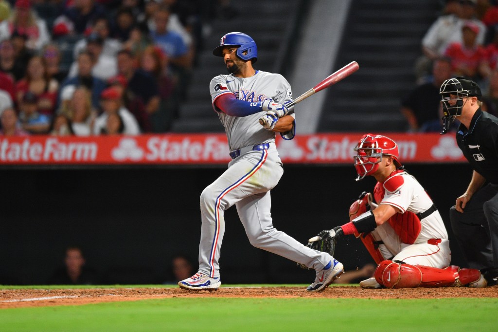 Rangers second baseman Marcus Semien (2) swings at a pitch