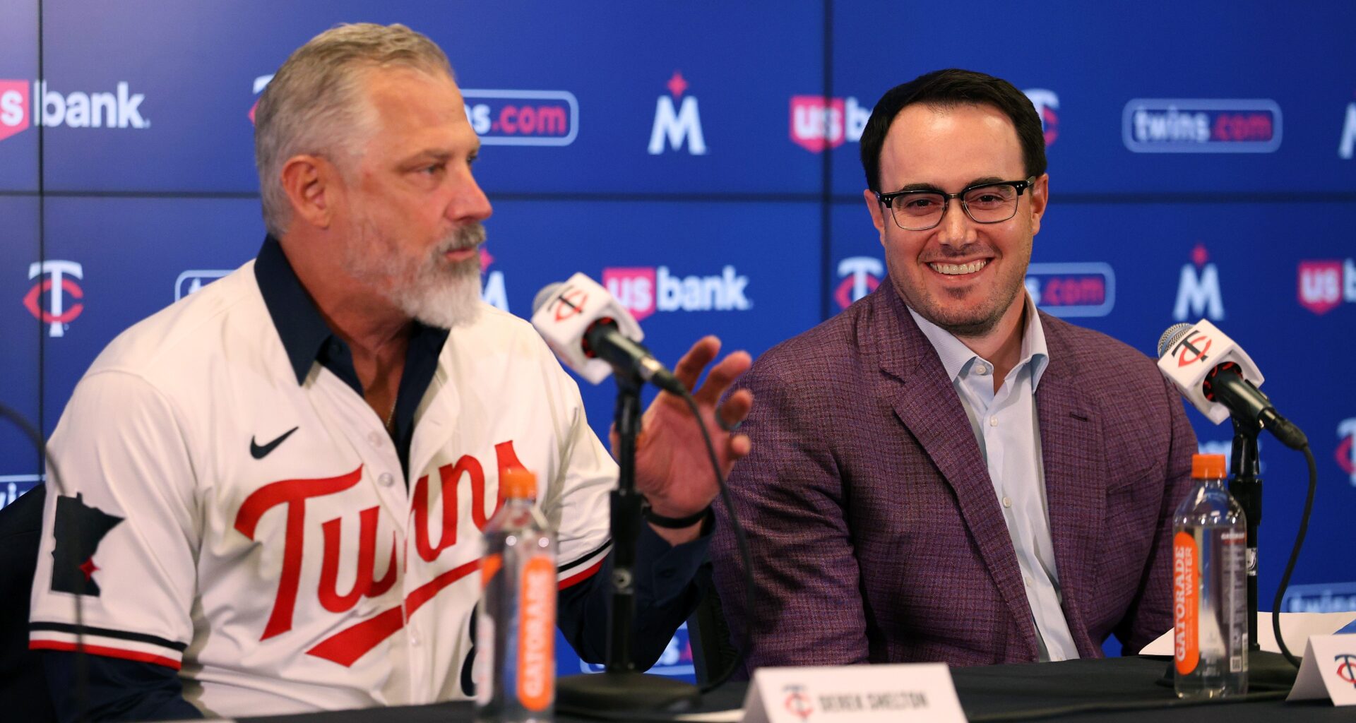 Manager Derek Shelton #8 of the Minnesota Twins addresses media as Vice President and Assistant General Manager Jeremy Zoll looks on during a press conference at Target Field on November 04, 2025 in Minneapolis, Minnesota.
