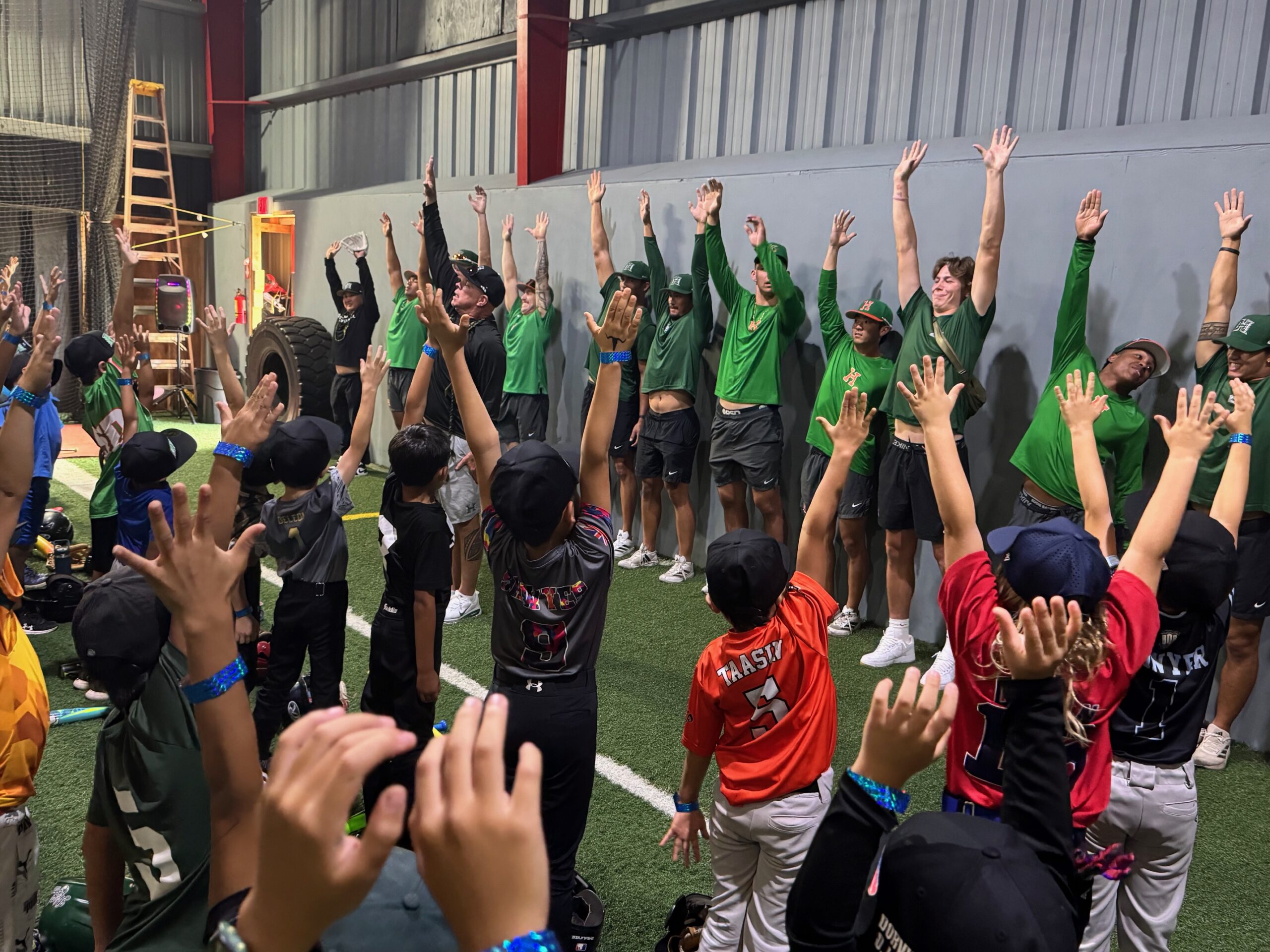 The University of Hawai'i baseball team works with Maui youth baseball players at Hitter's Paradise in Kahului on Saturday. HJI / ROB COLLIAS photo