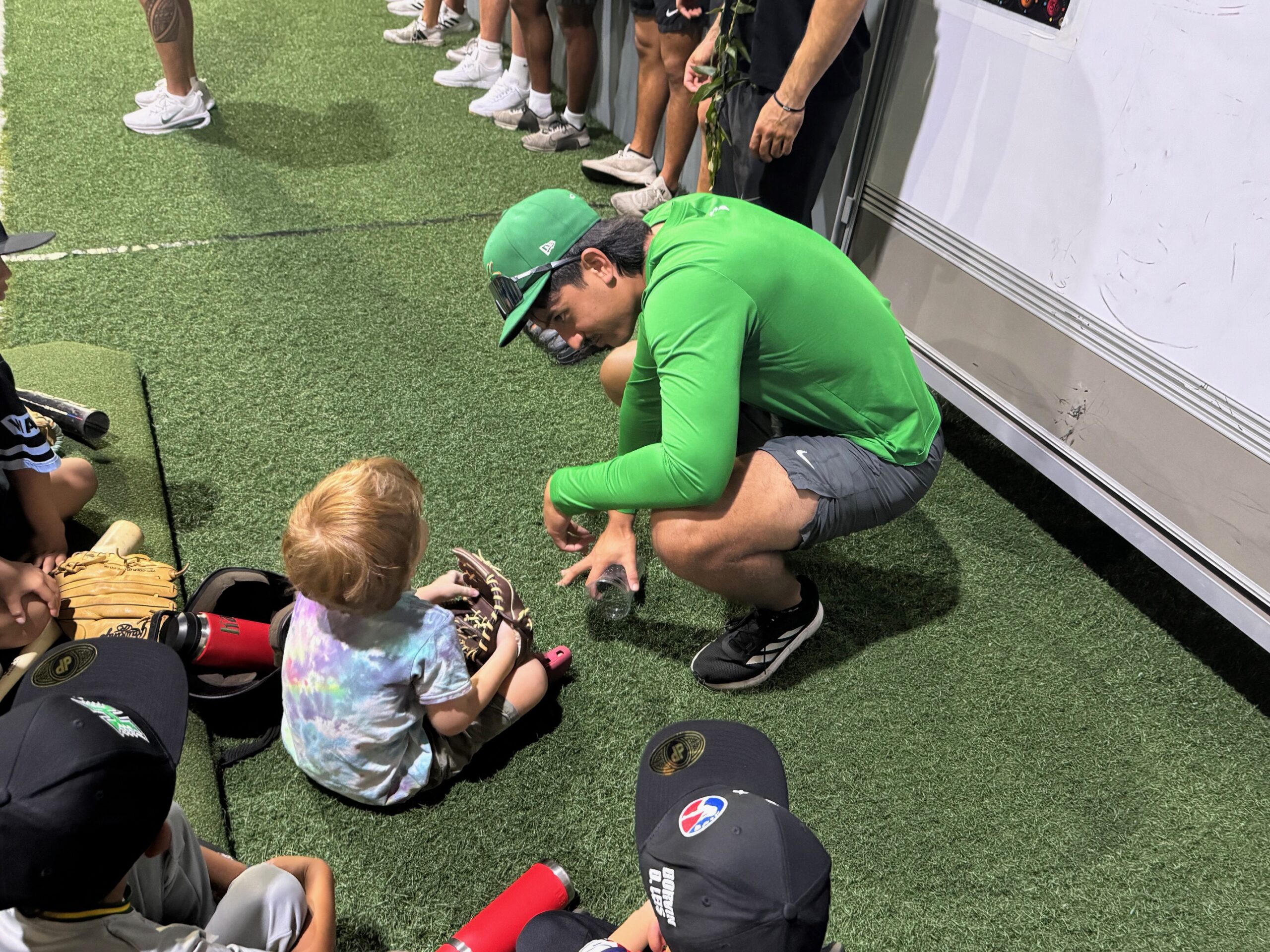 University of Hawaii baseball player Ben Zeigler-Namoa works with a youngster named Johnny on Saturday at a baseball clinic at Hitter's Paradise. HJI / ROB COLLIAS photo