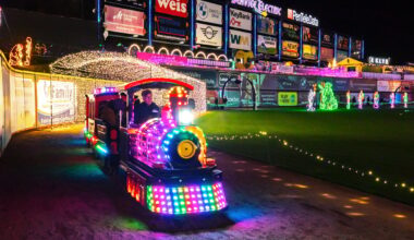 A train passes under a light tunnel at Illumination at Coca-Cola Park in Allentown PA