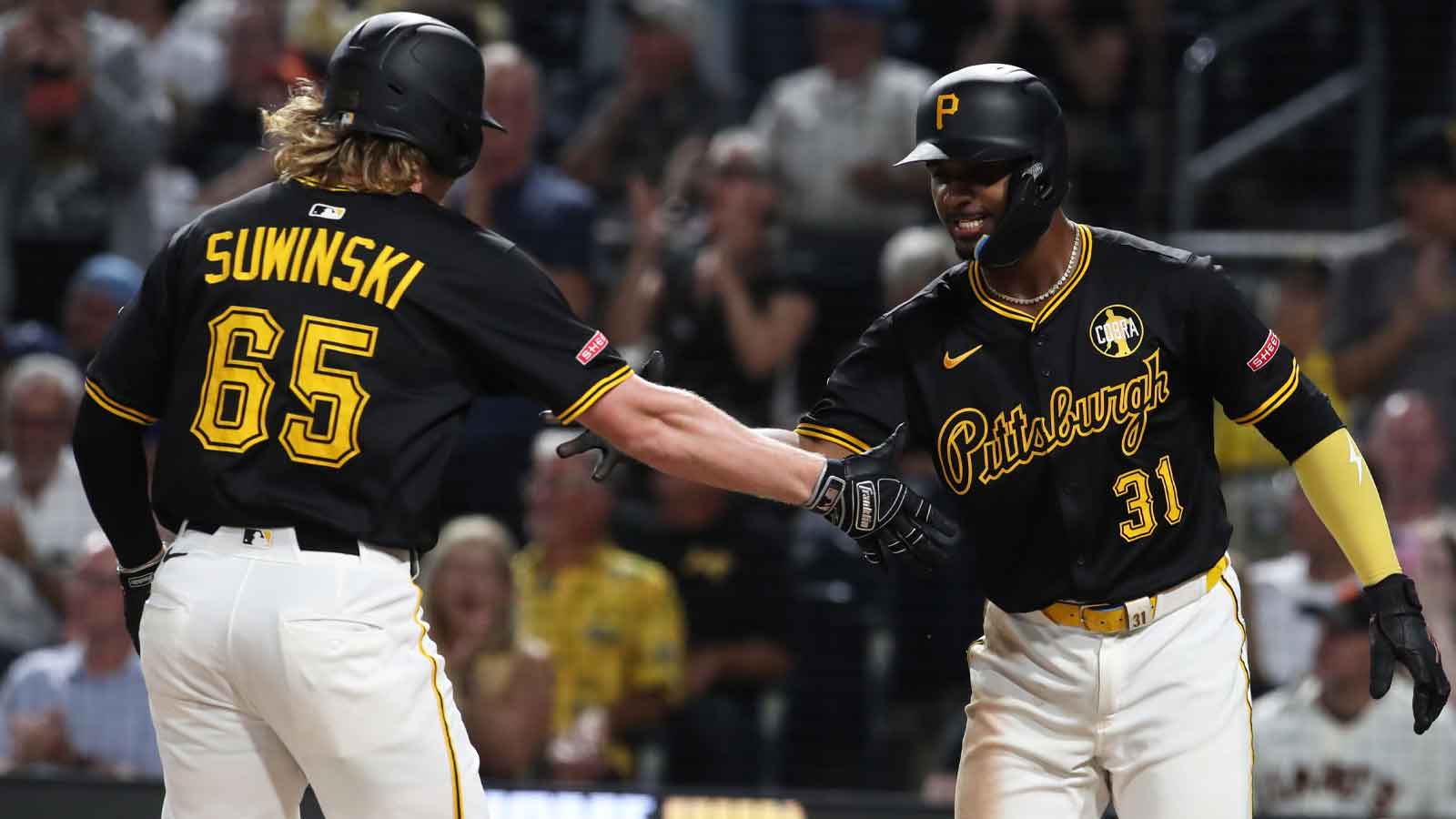 Pittsburgh Pirates shortstop Liover Peguero (31) greets right fielder Jack Suwinski (65) crossing home plate on a two-run home run against the San Francisco Giants during the seventh inning at PNC Park.