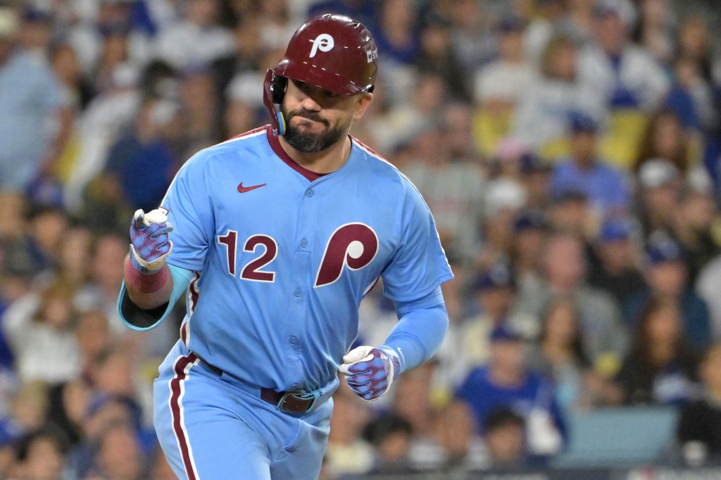 Philadelphia Phillies designated hitter Kyle Schwarber (12) looks into the dugout after hitting a solo home run during the fourth inning against the Los Angeles Dodgers in game three of the NLDS during the 2025 MLB playoffs at Dodger Stadium.
