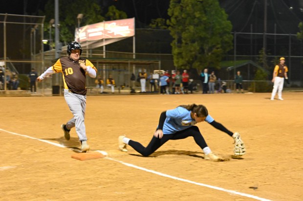 Poway Padres player Kyle Raney touches first base at the...