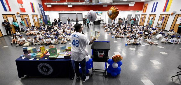 Ex-Los Angeles Dodger Dennis Powell reads “Abuela” on Thursday, Nov....