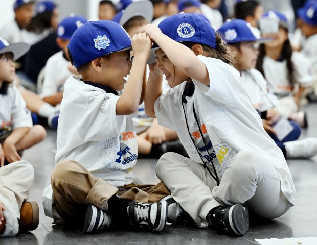 Kindergartners Moises Gutierrez, left, and Isabella Santamaria play with their...