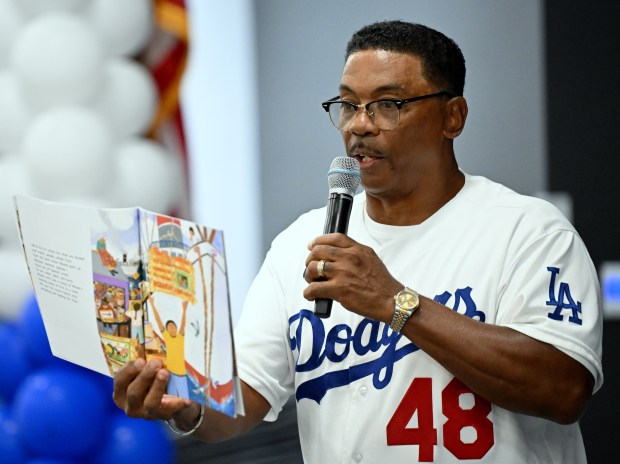 Ex-Los Angeles Dodgers player Dennis Powell reads “Abuela” to students...