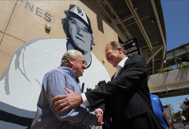 San Diego Mayor Kevin Faulconer greets former Padre Randy Jones in front of his new mural at the stadium. (Charlie Neuman, The San Diego Unio-Tribune)