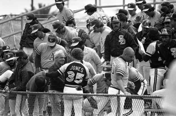 Baseball Player Association director Marvin Miller, left, is greeted by San Diego Padres players rep Randy Jones following a joint meeting of the Padres and Oakland A's, Thursday, March 27, 1980 in Scottsdale. At right is Oakland A's players rep Dave Heaverlo. Both teams voted unanimously to support a strike. (AP Photo)