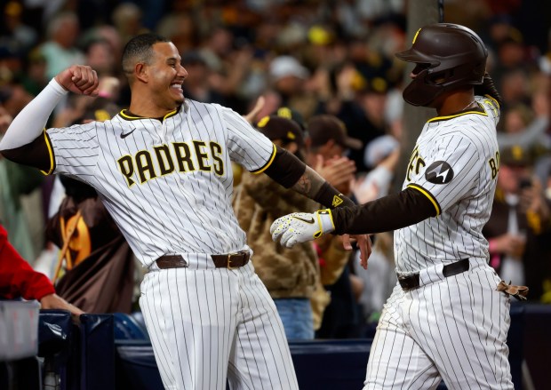 San Diego Padres' Xander Bogaerts celebrates with Manny Machado, left, after hitting a two-run home run in the seventh inning against the San Francisco Giants at Petco Park on April 29, 2025. (K.C. Alfred / The San Diego Union-Tribune)