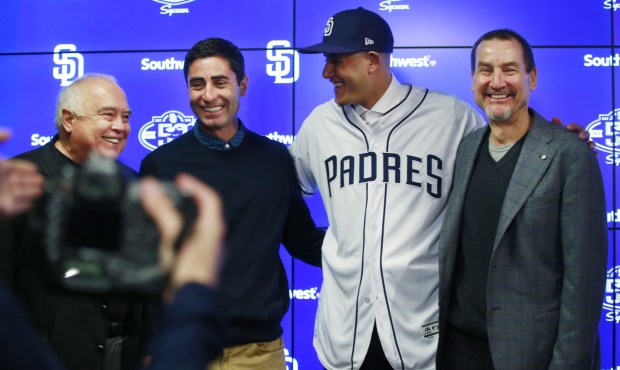 San Diego Padres executive chairman Ron Fowler, general manager A.J. Preller, infielder Manny Machado and general partner Peter Seidler take a photo after a news conference in Peoria on Feb. 22, 2019. Machado agreed to a 10-year, $300 million contract with the Padres. (Photo by K.C. Alfred/San Diego Union-Tribune)
