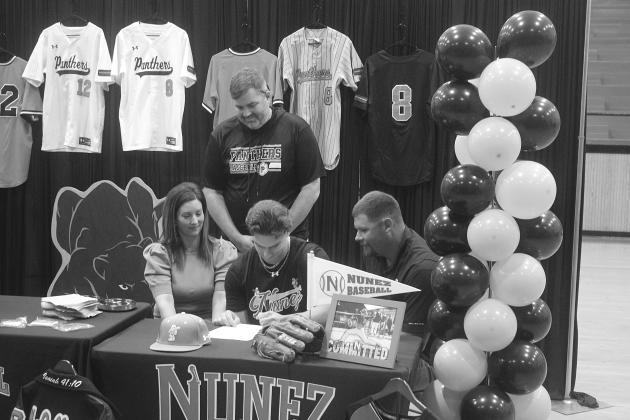 Tanner McCollough (center), of Pine Prairie High School, is pictured as he signs to play baseball at Nunez Community College. Pictured on the left is his mother, Allison, and on the right is his father, Tony. (Gazette photo by Tony Marks)