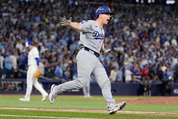 The Dodgers' Will Smith celebrates his home run against the Blue Jays during the 11th inning of Game 7 of the World Series on Nov. 2. (Brynn Anderson - The Morning Journal)