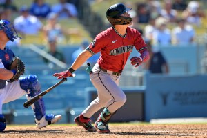 Aug 31, 2025; Los Angeles, California, USA; Arizona Diamondbacks left fielder Corbin Carroll (7) hits a three-run home run during the eighth inning off Los Angeles Dodgers relief pitcher Tanner Scott (66) at Dodger Stadium. Mandatory Credit: Jayne Kamin-Oncea-Imagn Images