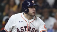 Sep 3, 2025; Houston, Texas, USA; Houston Astros first baseman Victor Caratini (17) hits a single during the fifth inning against the New York Yankees at Daikin Park. Mandatory Credit: Troy Taormina-Imagn Images
