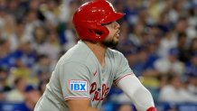 Sep 16, 2025; Los Angeles, California, USA;  Philadelphia Phillies catcher Rafael Marchan (13) watches the flight of the ball on a 3-run home run in the ninth inning against the Los Angeles Dodgers at Dodger Stadium. Mandatory Credit: Jayne Kamin-Oncea-Imagn Images