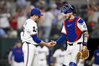 Sep 24, 2025; Arlington, Texas, USA; Texas Rangers relief pitcher Phil Maton (88) and catcher Jonah Heim (28) celebrate the win against the Minnesota Twins at Globe Life Field. Mandatory Credit: Jerome Miron-Imagn Images